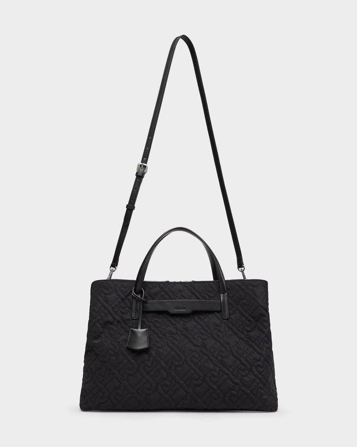 The Rudsak ASMINE - L325005 Black is a large tote with double top handles, adjustable shoulder strap, subtle embossed pattern, small hanging tag, and a minimalist, sophisticated design.