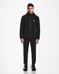 A man faces forward wearing the BILLY - U524501 Black M hoodie from Rudsak, paired with black pants and shoes against a plain white background—a perfect choice for sleek, minimal winter style.