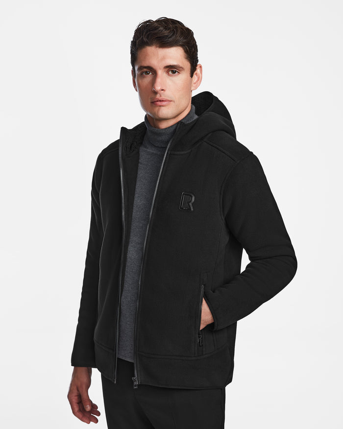 A man models the Rudsak BILLY - U524501 Black M jacket, featuring a polar fleece zip-up hoodie for versatile winter style.