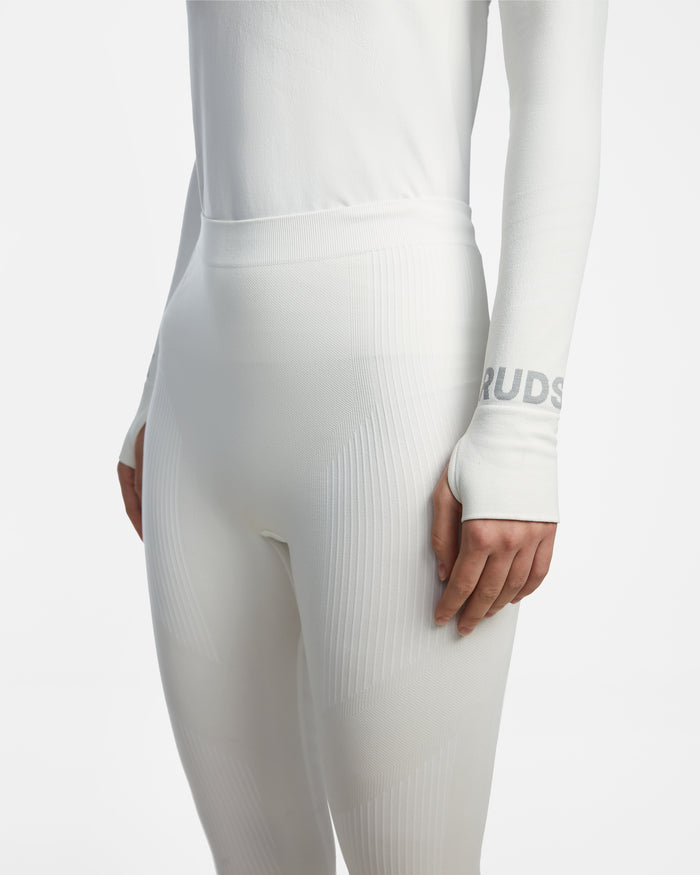A model in the CARRIE - 8524619 Iceland by Rudsak: a fitted, long-sleeve white top and high-waisted stretch leggings, RUDSAK logo partly visible on the sleeve—ideal as a women’s thermal set or ski base layer.