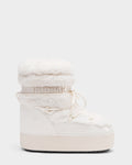 The Rudsak KATHY Y - 1224500 Iceland is a white winter boot with a thick sole, fluffy fleece collar, water-repellent patent leather, lace-up front, and RUDSAK branding on an elastic ankle band, inspired by classic moon boots.