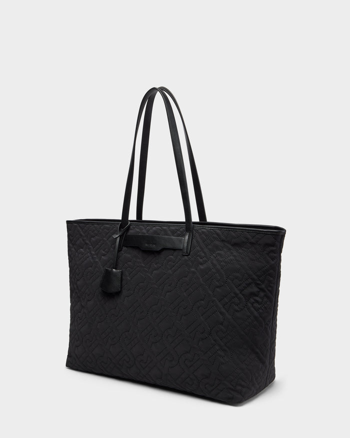 The Rudsak LIVORNO - L325007 Black is a sleek quilted monogram tote with a sturdy handle, perfect for carrying your essentials in style.