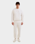 A man stands facing forward in the Rudsak MAXTON - U525007 Vanilla M cotton-blend jogger and sweatshirt with white sneakers, set against a plain white background for everyday comfort.