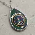 Morrison clan Scottish tartan necklace with clan crest and Teaghlach Phabbay motto on tartan background