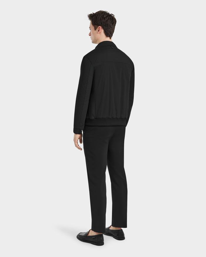 A man wearing the Rudsak PETER - 6125001 Black suit, showcasing modern design with vegan leather accents.