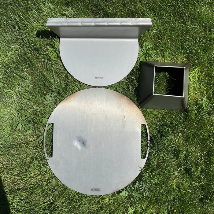 An arrangement of accessories for a Smokey Joe, on a grass background