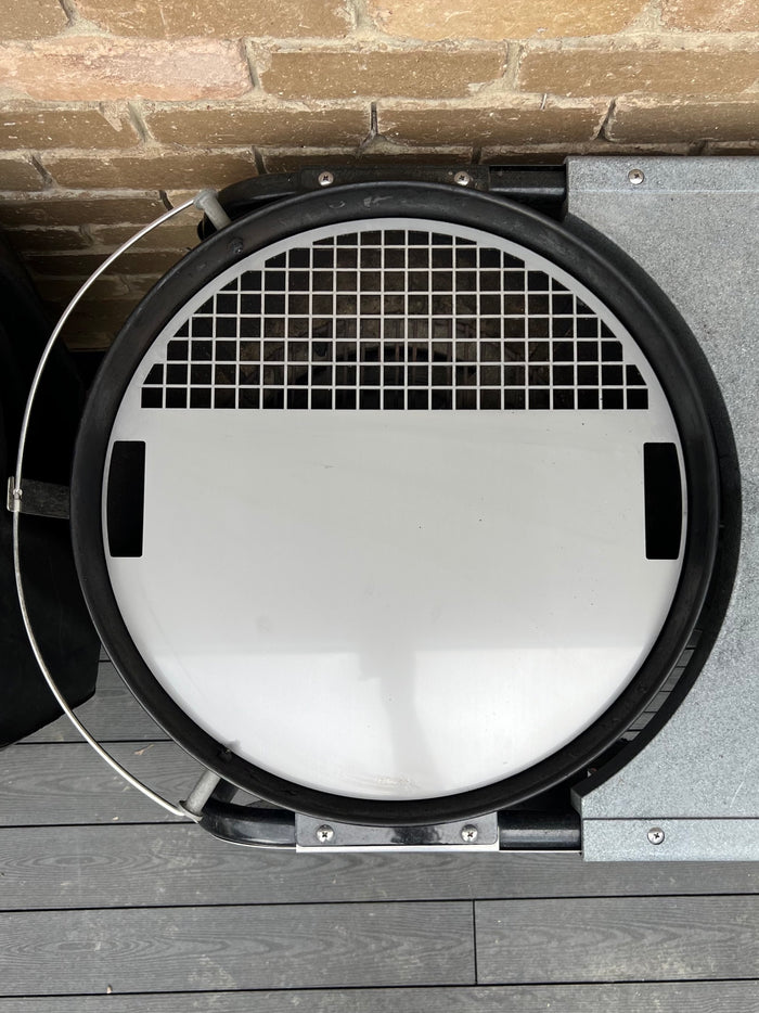 Stainless grill griddle plate fitted to a weber kettle top view