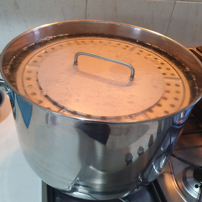 Stainless Weight being used to cooked grape leaves, dolmades, tolma, warak enab, and other stuffed dishes.