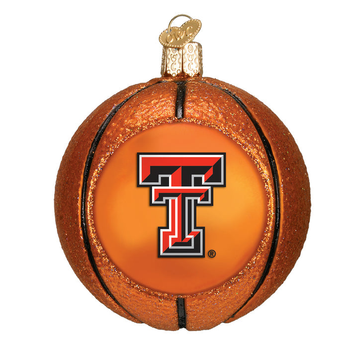 A Christmas ornament designed to look like a basketball, featuring the Texas Tech University double T logo in black, red, and white on the front.