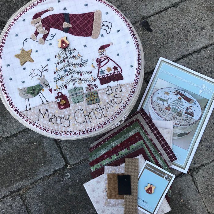 A kit for creating a Christmas-themed patchwork box with embroidery and appliqué, including materials like fabric, foam batting, and embroidery threads.