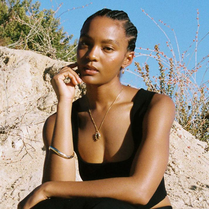 Model Wearing Gold Necklace with Modern Locket Outside