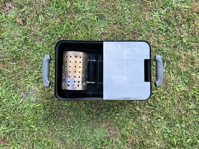top view of the half plate and chimney inside a weber GA with a grass background