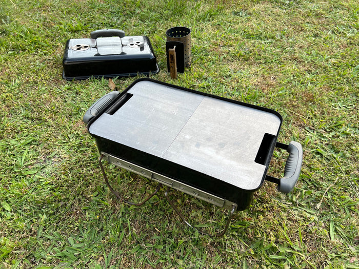 both half smash plates fitted to a weber go anywhere with a nice green grass backgrounf