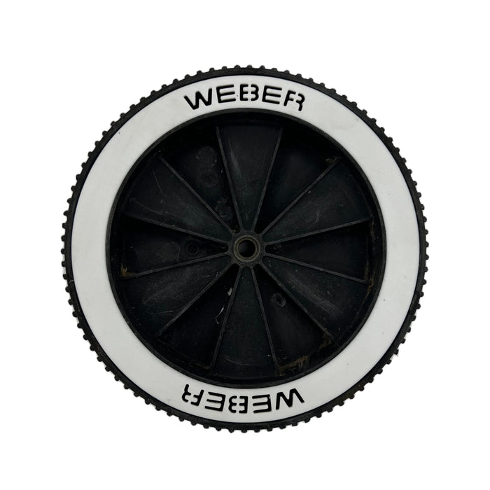 Old school weber genesis wheel inserts installed into a wheel with a white background