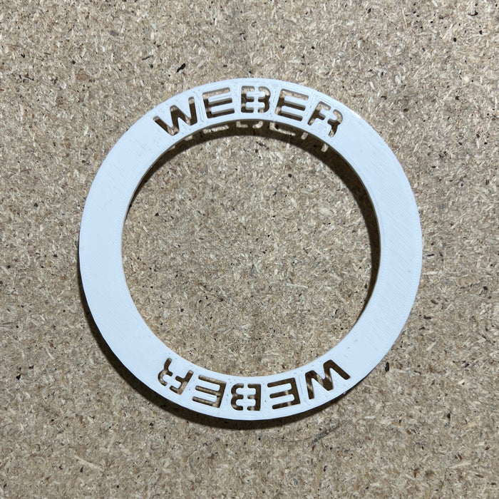 Weber wheel insert sitting on a bench unfitted